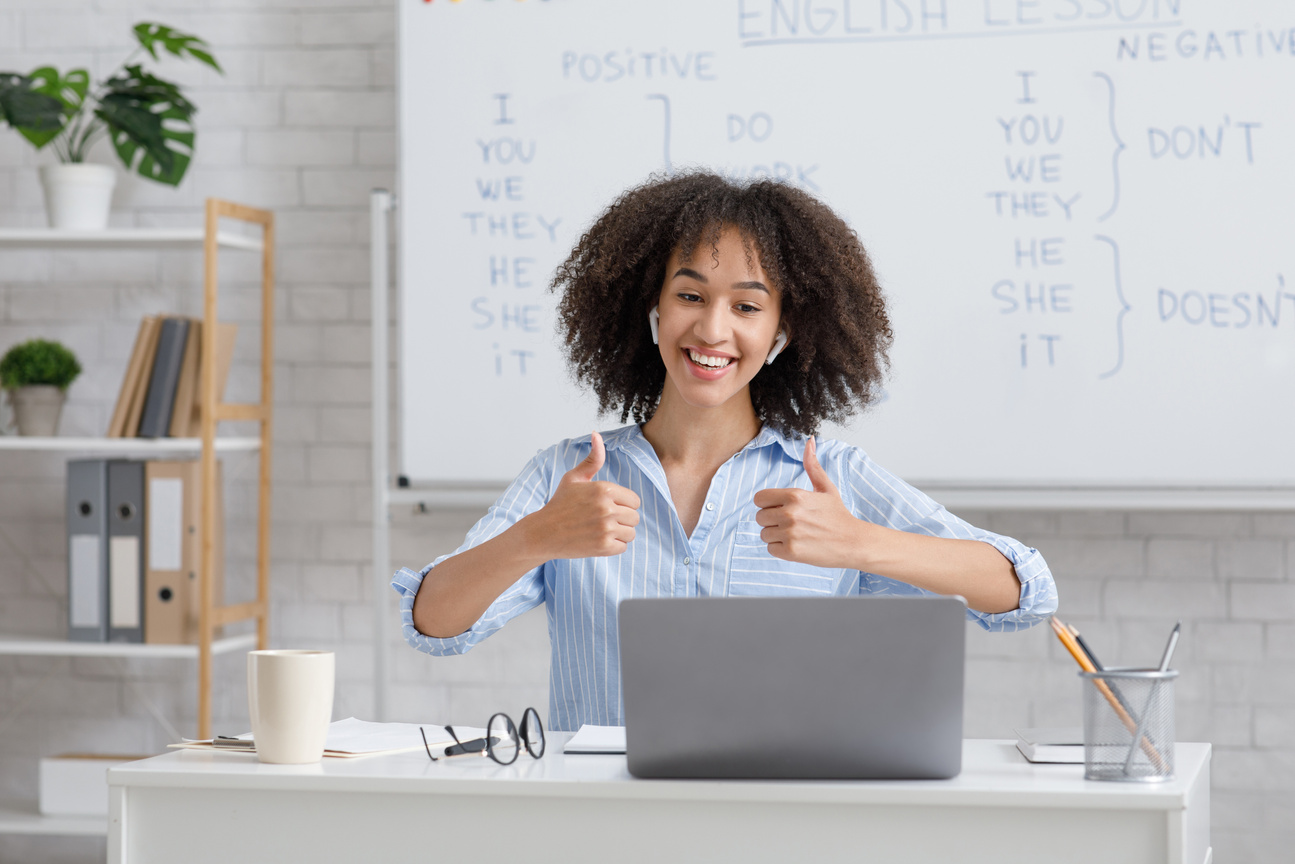 Excellent knowledge assessment. Cheerful african american lady showing thumbs up